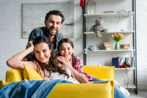 happy-family-sitting-couch-living-room-1